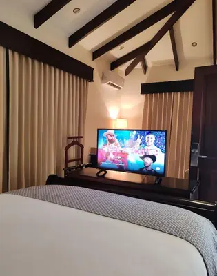 a bedroom with a bed and a flat screen tv at Marenaz Oceanfront Resort in Esterillos Este