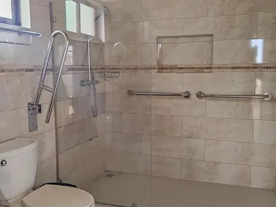 a bathroom with a shower with a toilet at Marenaz Oceanfront Resort in Esterillos Este