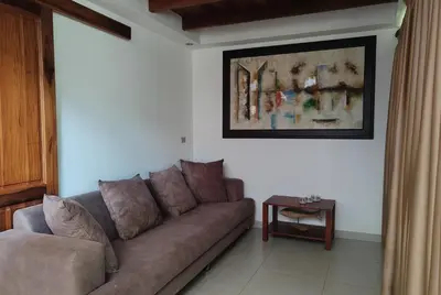 a living room with a couch and a table at Marenaz Oceanfront Resort in Esterillos Este
