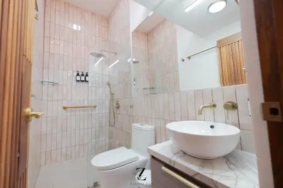a bathroom with a sink and a toilet and a shower at Zapote Zen in San José