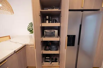 a kitchen with a pantry with a refrigerator at Zapote Zen in San José