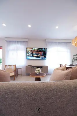 a living room with a couch and a flat screen tv at Zapote Zen in San José