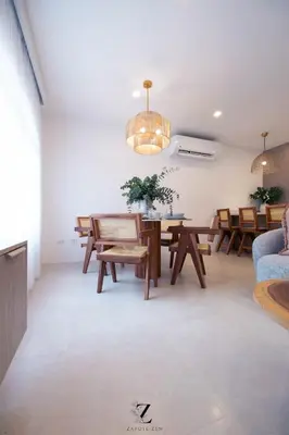 a living room with a dining room table and chairs at Zapote Zen in San José