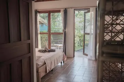 a bedroom with a bed and a large window at Finca Bavaria in Ballena