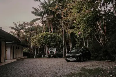 a car parked in front of a house with trees at Finca Bavaria in Ballena