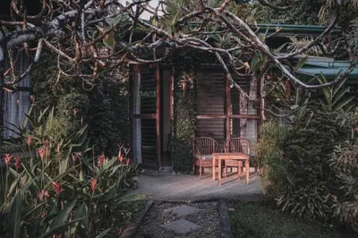 a table and chair in front of a house at Finca Bavaria in Ballena