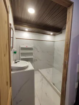 a white bathroom with a sink and a shower at Pura Vida Rentals in Cabuya