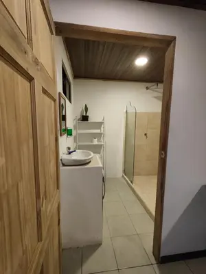 a bathroom with a sink and a shower at Pura Vida Rentals in Cabuya