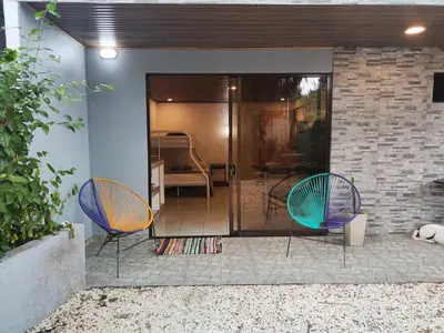 two chairs sitting on a patio in front of a house at Pura Vida Rentals in Cabuya