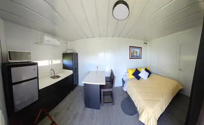 a small bedroom with a bed and a sink in it at Dadirri Cozy House Santa Elena Monteverde in Monteverde Costa Rica