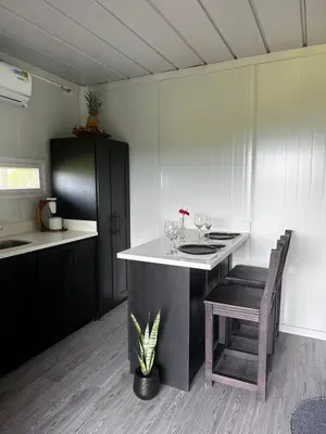 a kitchen with a island with a table and chairs at Dadirri Cozy House Santa Elena Monteverde in Monteverde Costa Rica