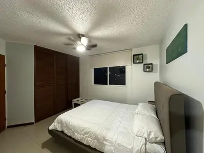a bedroom with a bed and a ceiling fan at DURCH PROJECT apartamento vacacional in Jacó