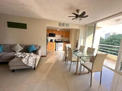 a living room with a couch and a table and chairs at DURCH PROJECT apartamento vacacional in Jacó