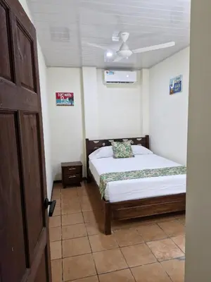 a bedroom with a bed and a ceiling fan at Manuel Antonio Tropical Twins in Quepos