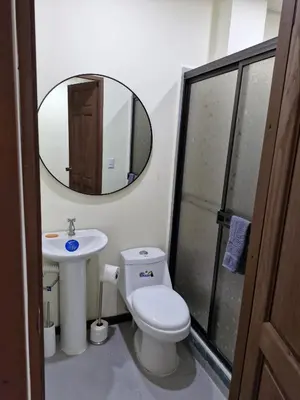 a bathroom with a toilet and a sink and a mirror at Manuel Antonio Tropical Twins in Quepos