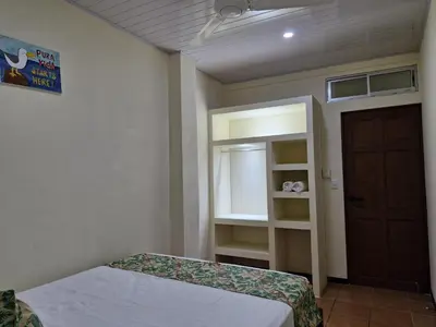 a bedroom with a bed and a window and a door at Manuel Antonio Tropical Twins in Quepos