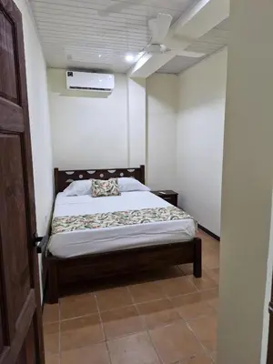 a bedroom with a bed in a room at Manuel Antonio Tropical Twins in Quepos