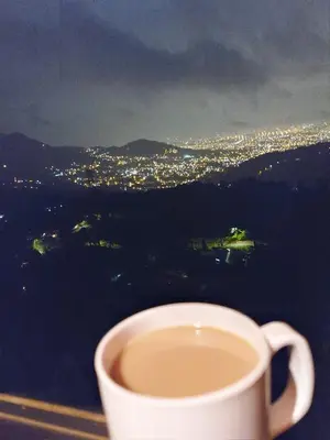 a cup of coffee sitting on top of a table at Vista Hermosa Lodge in Aserrí