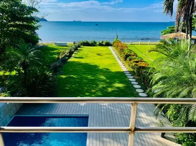 a view of the ocean from the balcony of a house at Gorgeous Beachfront Home in Playa Potrero in Playa Flamingo