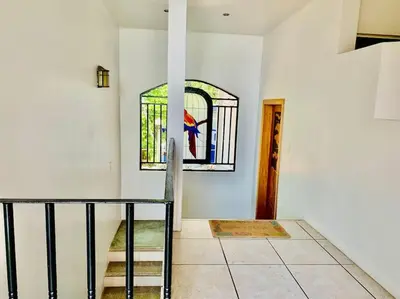 a room with a staircase and a stained glass window at Gorgeous Beachfront Home in Playa Potrero in Playa Flamingo