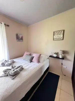a bedroom with a bed with towels on it at Apartamentos del Sol #2 in Tilarán