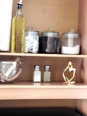 a wooden shelf with jars and bottles on it at Apartamentos del Sol #2 in Tilarán