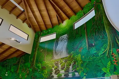 a room with a jungle mural on the wall at MonkeyRanch LuxLodge in Dominicalito