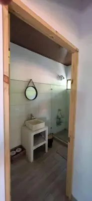 a bathroom with a sink and a mirror at Cabinas Guacamaya in Cabuya