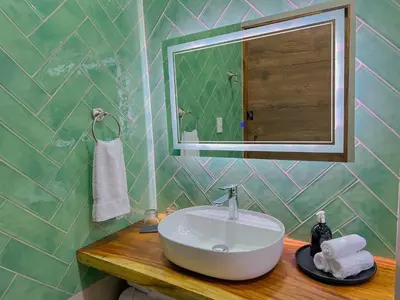 a bathroom with a sink and a mirror at Monstera Apartments Monteverde in Monteverde Costa Rica