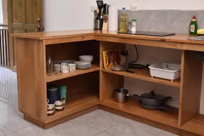 a wooden kitchen shelf with dishes and utensils at Casa Jaspe Monteverde - Balcón vista en Monteverde in Monteverde Costa Rica