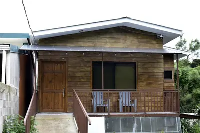 a house with a deck with two chairs on it at Casa Jaspe Monteverde - Balcón vista en Monteverde in Monteverde Costa Rica