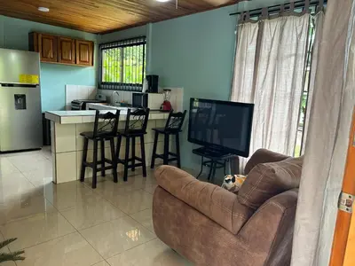 a living room with a couch and a tv and a kitchen at Casa anturio 2 in Fortuna