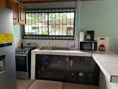 a kitchen with a sink and a stove and a window at Casa anturio 2 in Fortuna