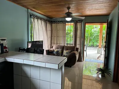 a kitchen and living room with a couch and a table at Casa anturio 2 in Fortuna