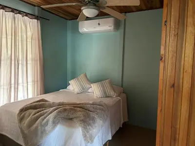 a bedroom with a bed with a blanket on it at Casa anturio 2 in Fortuna