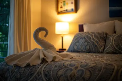 a swan decoration on a bed in a hotel room at Four Winds Properties A Short Walk to the Beach in Nosara