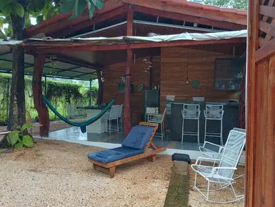 a patio with a hammock and a house at Blue Zone Cozy Cabaña Peaceful Getaway in Santa María