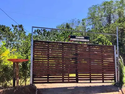 a wooden fence with a sign on top of it at Blue Zone Cozy Cabaña Peaceful Getaway in Santa María