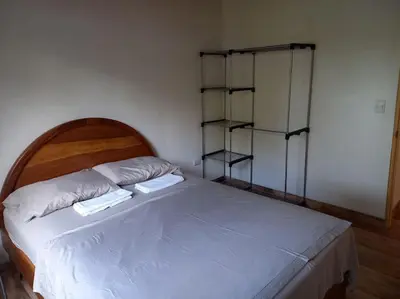 a bed with two white towels on top of it at Cabinas Guacamaya Cabuya - 2 cuartos in Cabuya
