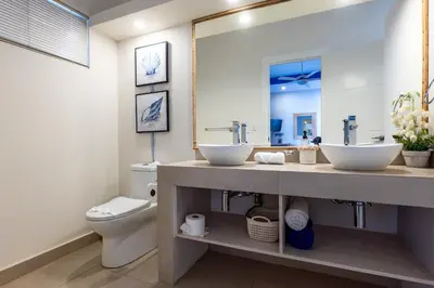 a bathroom with two sinks and a toilet at Casa Karibe in Tamarindo