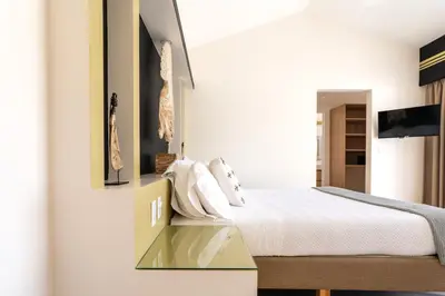 a bedroom with a bed and a tv on a wall at Casa Karibe in Tamarindo
