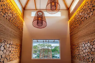 a room with a window and two chandeliers at Casa Karibe in Tamarindo