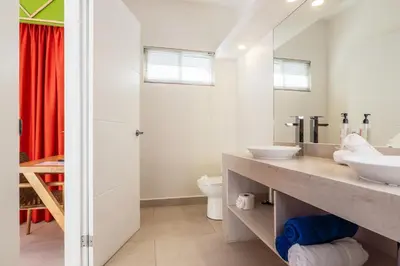 a bathroom with two sinks and a shower at Casa Karibe in Tamarindo