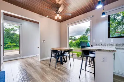 a kitchen and dining room with a table and stools at Monte Donato 18 - Apt 1 in Playa Avellana