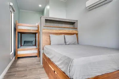 a bedroom with a bed with a wooden headboard at Monte Donato 18 - Apt 1 in Playa Avellana