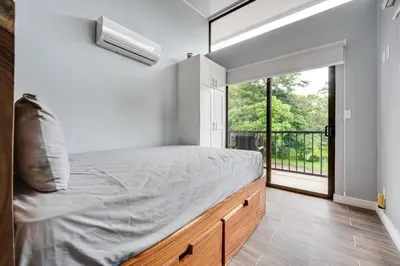 a bedroom with a bed and a large window at Monte Donato 18 - Apt 1 in Playa Avellana