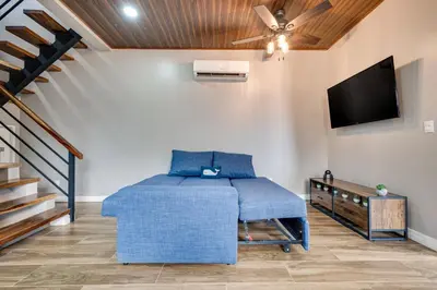 a room with a bed and a flat screen tv at Monte Donato 18 - Apt 1 in Playa Avellana