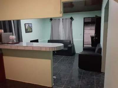 a living room with a table and two chairs at Angel Bee Lodge in Fortuna