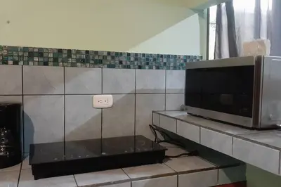 a living room with a tv and a microwave at Angel Bee Lodge in Fortuna