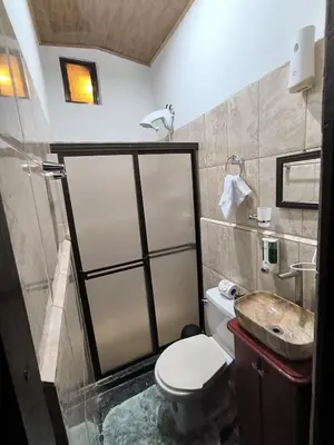 a bathroom with a toilet and a sink at Angel Bee Lodge in Fortuna